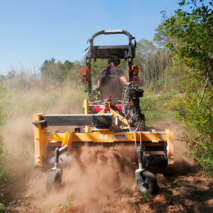 Nortec Raptor Compact Power Rake on Dirt Trail