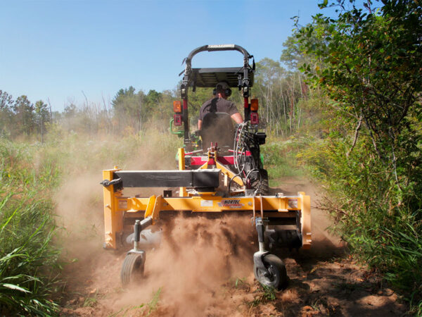 Nortec Raptor Compact Power Rake on Dirt Trail